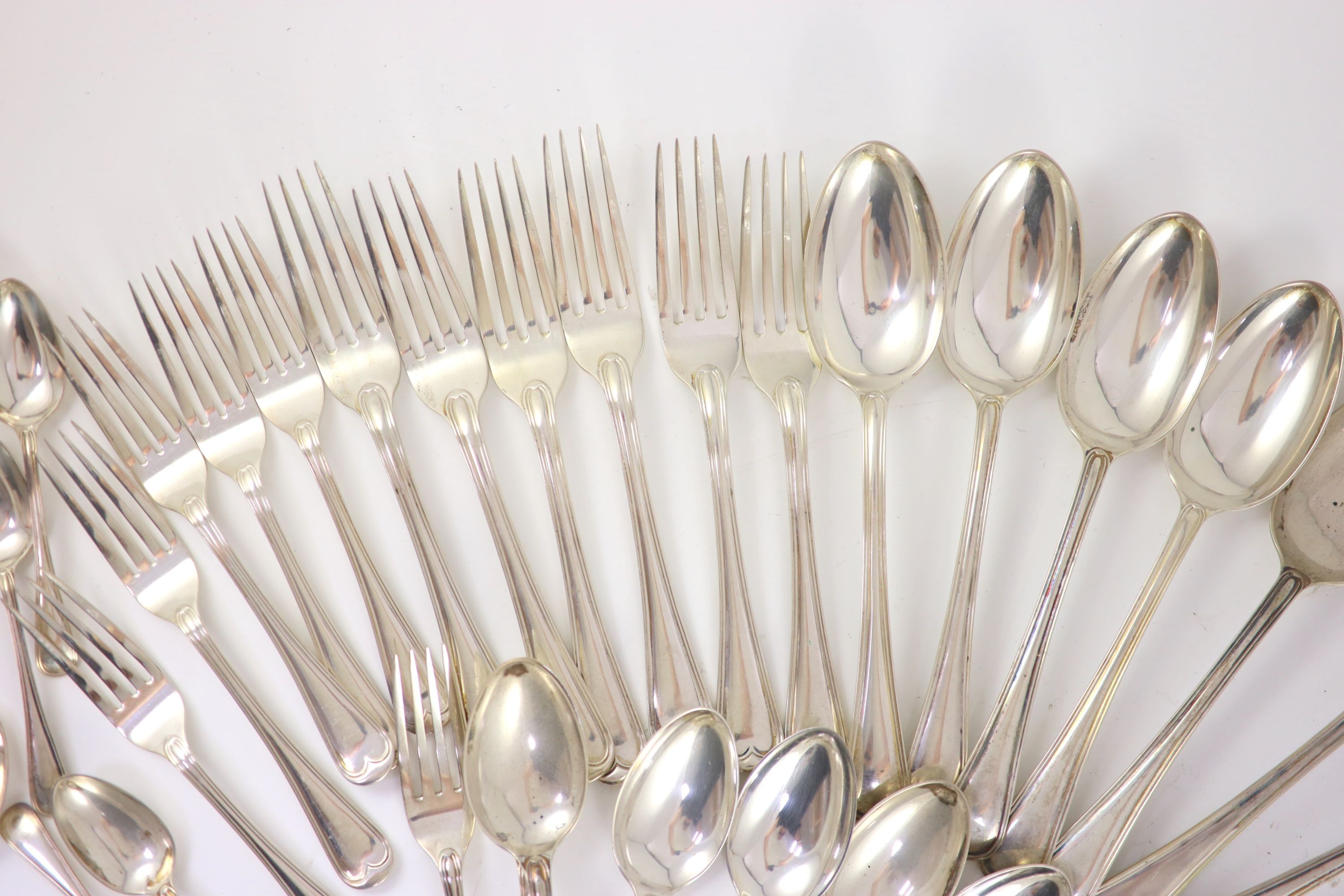 A part canteen of Edwardian silver Old English double struck thread pattern flatware for twelve by John Round & Son Ltd